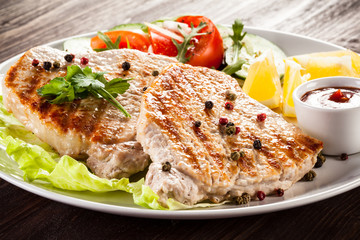 Grilled steaks and vegetable salad
