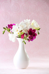 Beautiful spring flowers on pink background