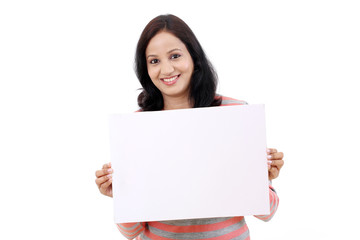 Cheerful young woman holding empty white board