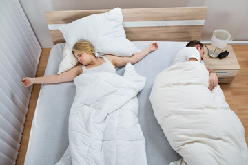 Portrait Of Couple Lying In Bed