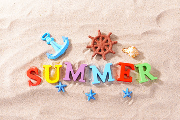 Word summer on beach background