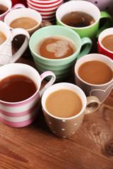 Cups of cappuccino on wooden table, closeup