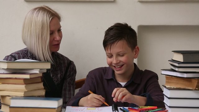 Tutor teaches a young student with his studies.