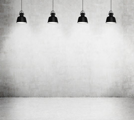 Concrete room with four black lamps.