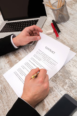 A businessman signing a Contract.