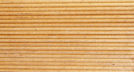 Wooden light brown grooves panel closeup