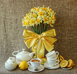A festive tea party and a vase with daffodils.