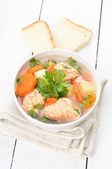 Fish soup on white wooden table