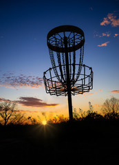 Obraz premium Disc golf basket against sunset