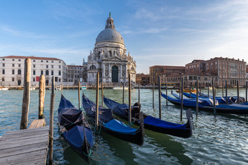 Fototapeta na wymiar Gondolas in Grand Canal and Basilica Santa Maria della Salute in