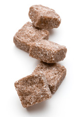 Brown lump cane sugar cube isolated on white background cutout