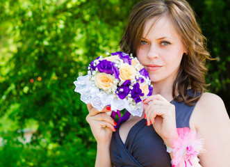 Fototapeta premium Lovely bridesmaid with flower bouquet