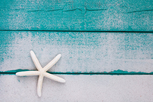 Blank beach sign with starfish and sand