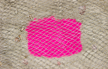 Blank pink sign surrounded by beach with fish net overlay