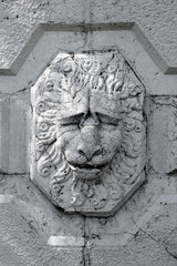 Lion's head carved in a stone column