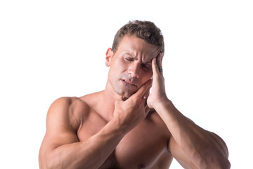 Fototapeta premium Muscular handsome man holding his head with for headache