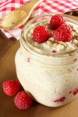 Overnight breakfast oats with raspberries in a mason jar