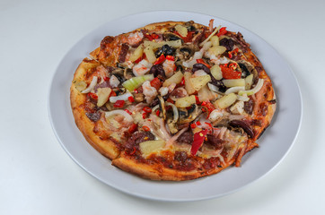 Small pizza on a plate on white background
