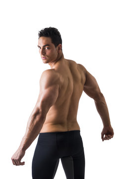 Back shot of shirtless muscular young man, relaxed