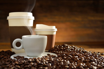 Cups of coffee  and coffee beans on old wooden background