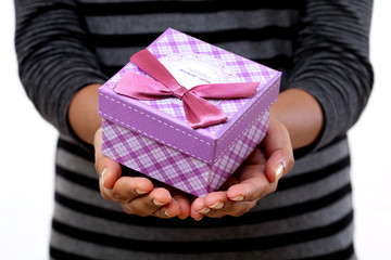 Female hands holding small gift box