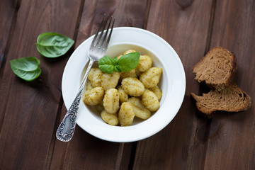 Boiled gnocchi with pesto sauce, high angle view, studio shot