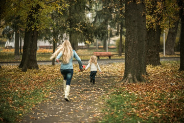 Fototapeta premium Mother with daughter in autumn park