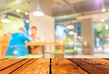Empty wood table and Coffee shop blur background with bokeh imag