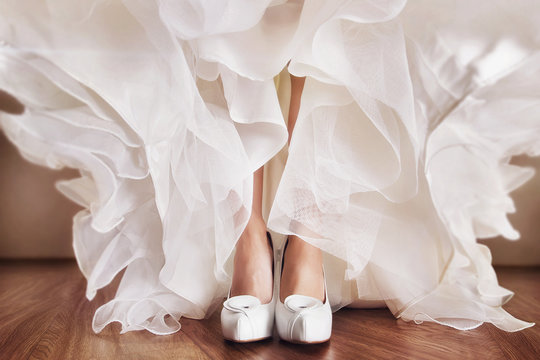 A close up image of elegant floor-length wedding dress. Concept