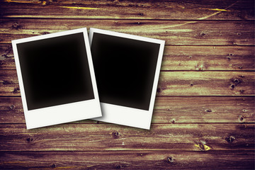 Photo frames on vintage wooden board background texture