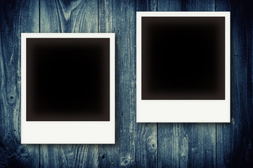 Photo frames on vintage wooden board background texture