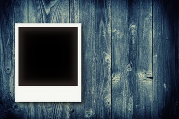 Fototapeta premium Photo frames on vintage wooden board background texture