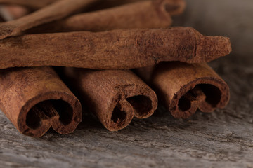 whole cinnamon sticks on wooden background