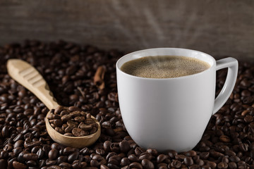 Cup French coffee with cinnamon sticks and  background beans