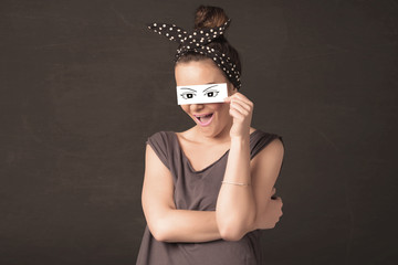 Silly youngster looking with hand drawn eye paper