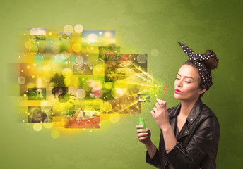 Obraz premium Cute girl blowing colourful glowing memory picture concept