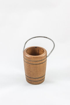 a miniature wooden bucket with metal handle