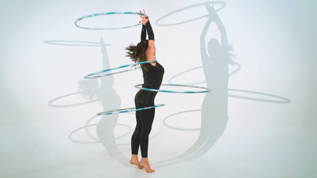 Spinning acrobat beautiful hula hoops in slow motion