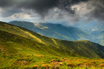 Summer landscape in the mountains. Dramatic overcast sky.