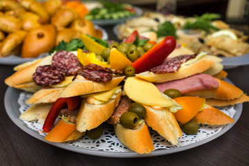 bread with cheese and salami sliced on round plate