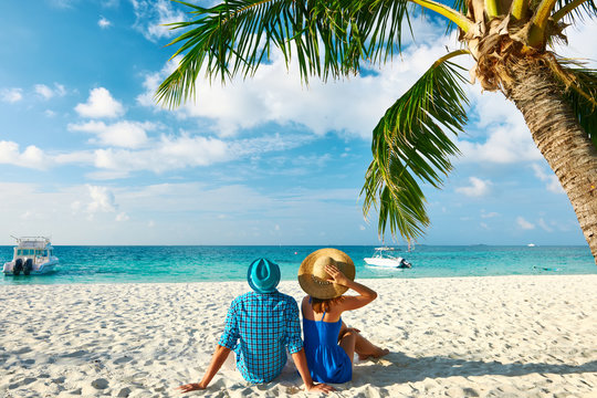 Couple in blue clothes on a beach at Maldives