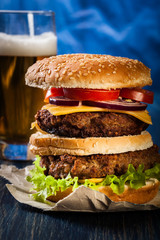 Hamburger on paper with beer