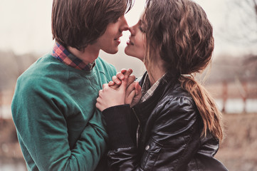 Fototapeta premium close up outdoor portrait of happy young couple kissing