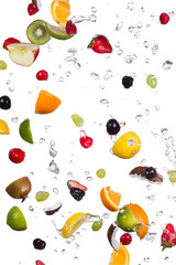 Mix of fruits with water splashes on white