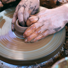 Hands working on pottery wheel