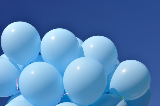 blue balloons on blue sky background