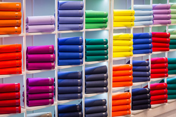 Colorful sweaters on the shop shelfs - obrazy, fototapety, plakaty