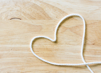 Obraz premium Heart Rope on a Wooden background