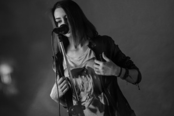 girl singing into a microphone in a studio