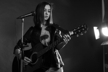 Fototapeta premium the girl playing guitar in the Studio